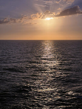 Sea glittering waves and dusk sky at evening.