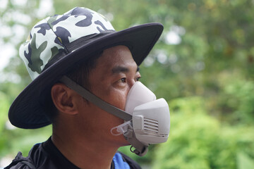 Close-up of protective face mask used by farmer during pesticide or chemical spraying. The mask helps prevent inhalation of toxic substances. Concept safety and health in agricultural environments.  