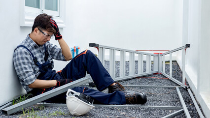 Asian construction foreman injured by broken head while working at building site. Male worker head...