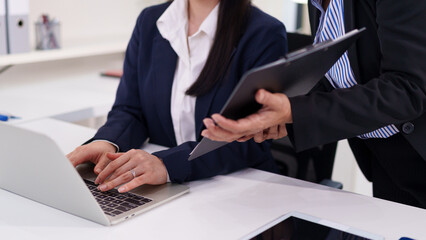 Asian Women Collaboration with Older Asian Colleague on Laptop for Business Growth Strategy and...