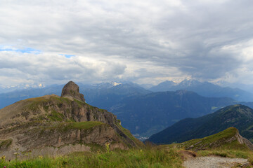 Mountain panorama with summit Pointe de Chemo and mountain massif Grand Combin in the background and clouds in Swiss Alps, Switzerland