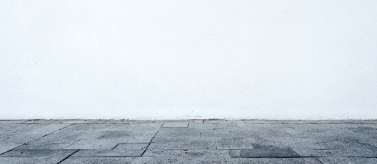Blank white wall and gray paving stones