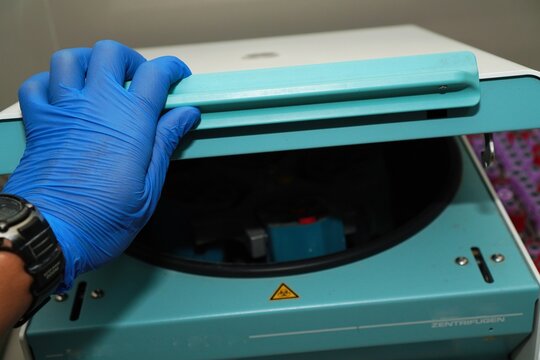 Laboratory equipment centrifuge in hospital or clinic. Blue medical centrifuge with blood tube.Device for laboratory research.Modern lab technology.