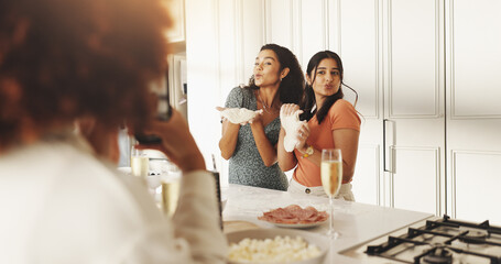 Women, friends and cooking with photo, phone and happy with dough, pout and post on web in home. People, group and recipe with kiss, flour and ingredients with food on social network in kitchen