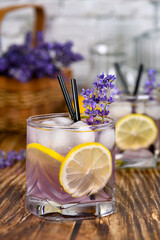  A glass of homemade lavender lemonade. Garnished with lemon wedges and lavender sprigs