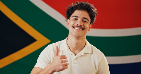South Africa, flag and portrait of happy man with thumbs up, confidence and country loyalty....