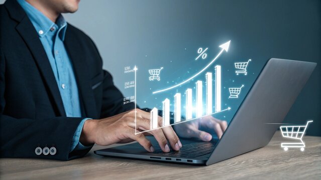 Businessman analyzing financial growth charts and shopping cart icons on a laptop screen representing e commerce success - Powered by Adobe