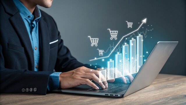 Businessman analyzing rising sales data and online shopping trends on a laptop with glowing virtual charts and shopping carts