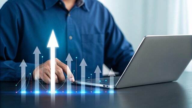 Man in blue shirt using laptop with glowing upward arrows and data charts representing financial growth and success