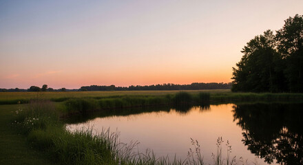 Obraz premium Sunset glow reflects on still pond