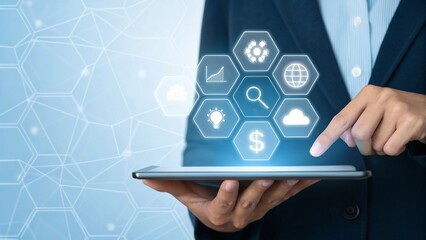Business professional using a tablet displaying glowing digital icons for finance technology and global connectivity in a modern office setting