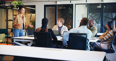 Woman, speaker and meeting with staff in office for discussion, planning and ideas for headline. Manager, talking and people listen to article feedback, brainstorming and proposal of online magazine