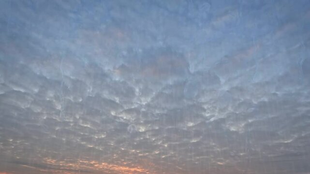 timelapse of the sky of rain at nice sundown with clouds - loop video