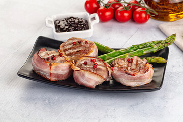 Tasty grilled pork medallion with bacon