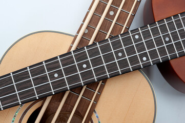 Fototapeta premium Four-string bass ukulele with wooden body and built-in tuner and pickup.
