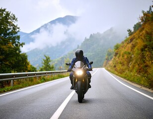 Motorcycle on a road in the foggy mountains