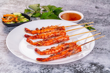 Grilled prawn skewer served sauce
