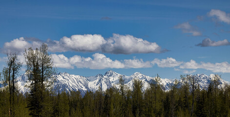 Clouds over mountains on sunny day in Alaska