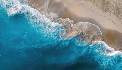 Fototapete Aerial view of waves crashing on a sandy beach (1) © Ratna