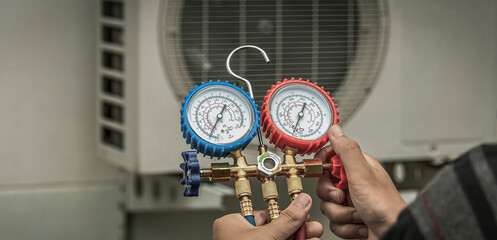 Technician checking the operation of the air conditioner