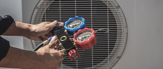 Technician checking the operation of the air conditioner.