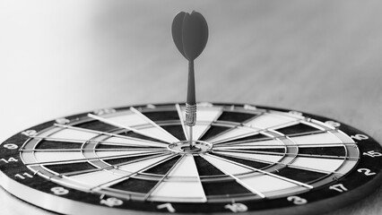 Darts arrows hitting the center of dartboard, business success concept