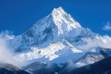 Obraz premium Snow-capped peak rises majestically against a deep blue sky, showcasing the allure of nature in its purest form and inviting adventure for climbers and explorers alike