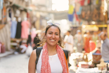 Tourist smiling and walking in a middle eastern market