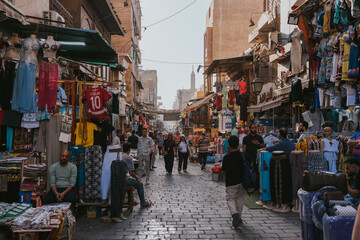 People walking and shopping in a busy street market in cairo, egypt