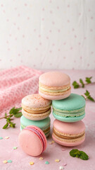 Pastel Macarons Stacked on Pink Surface with Mint and Confetti