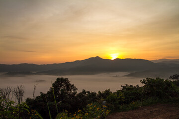 light of sunrise over mountain with sea of mist