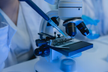 two scientists are working together to find a new antiviral drug, two chemists are using scientific tools to study science, microscope, working in the lab, researchers' work in the laboratory