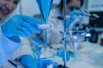 two scientists are working together to find a new antiviral drug, two chemists are using scientific...