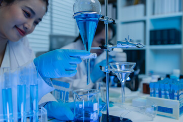 two scientists are working together to find a new antiviral drug, two chemists are using scientific...