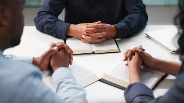Group Of Diverse People Reading Bible And Praying Together In Church