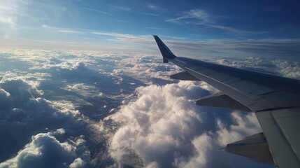Fototapeta premium Aerial View of Wispy Clouds Under a Clear Sky as Seen from an Airplane Wing During a Serene Flight Over Scenic Landscapes