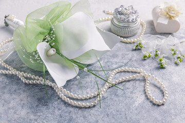 Wedding still life with pearl necklace and bouquet