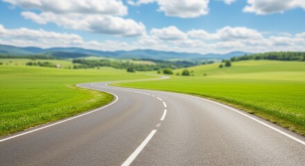Fototapeta premium Winding Gray Road Through Sunny Green Landscape with Blue Sky