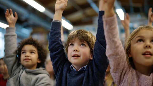 Group of schoolchildren eagerly raising their hands during a classroom activity, expressing enthusiasm, curiosity, and active participation in learning.