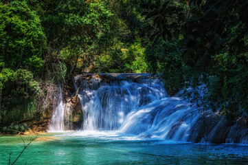 Close up of a cascade of the Agua Azul waterfalls in the rainforest of Chiapas, Palenque, Mexico.