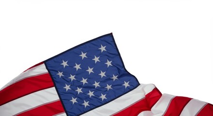 Corner of an American flag blowing gently in wind motion, captured close-up against an all-white background.