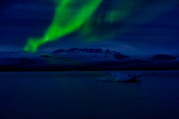 Night of Aurora borealis northern light above Jokulsarlon glacial lagoon, Iceland for travel destination.