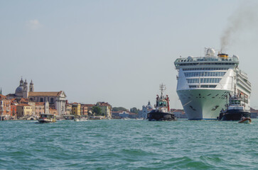 Italian luxury cruise ship Victoria cruising the Giudecca Canal with tug boats towards the cruise...