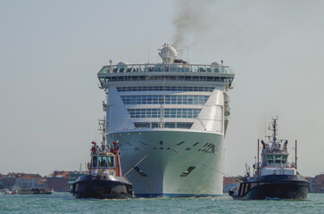 Italian luxury cruise ship Victoria cruising the Giudecca Canal with tug boats towards the cruise...