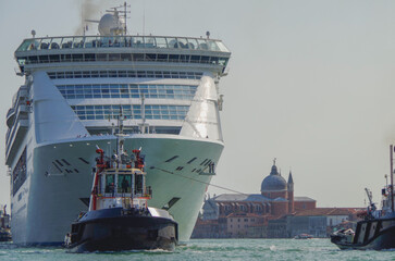 Italian luxury cruise ship Victoria cruising the Giudecca Canal with tug boats towards the cruise...
