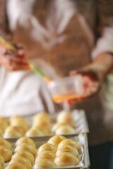 Toasted Mung Bean Cake from the oven. Chinese pastry or moon cake filled with sweet mung bean paste and salted egg yolk. Delicious pastry.