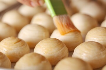Toasted Mung Bean Cake from the oven. Chinese pastry or moon cake filled with sweet mung bean paste and salted egg yolk. Delicious pastry.