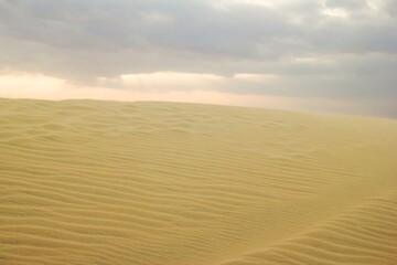 Golden Desert Landscape with Dramatic Sky Serene Nature. Mui Ne, Vietnam, White Dunes.