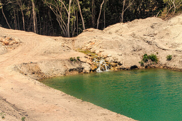 In the rock-strewn savanna under scorching, grass-parching heat, a hidden water source flows...