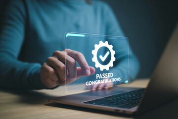 A person interacts with an online exam passed congratulations screen displayed on a laptop